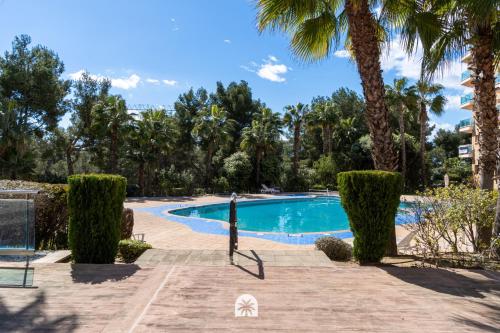 a swimming pool in a resort with palm trees at Mediterranean Way - Ontario in Salou