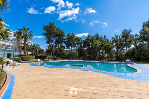 a swimming pool at a resort with palm trees at Mediterranean Way - Ontario in Salou