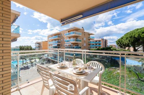 a balcony with a table and chairs and a view of a building at Mediterranean Way - Ontario in Salou