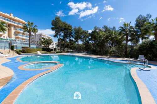 a swimming pool in a resort with palm trees at Mediterranean Way - Ontario in Salou