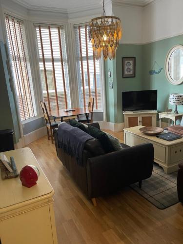 a living room with a couch and a table at Beach House in Lytham St Annes