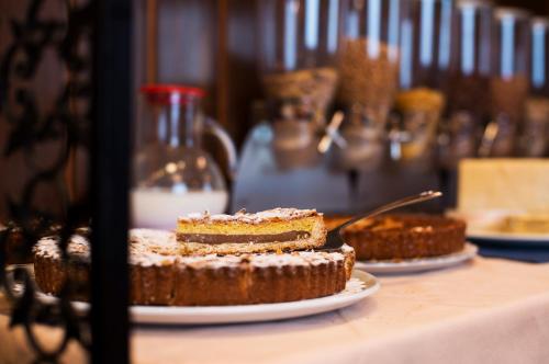 a piece of cake on a plate on a table at Hotel Mec in Milan