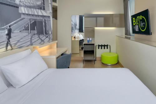 a bedroom with a white bed and a desk at B&B Hotel Milano Sesto Marelli in Sesto San Giovanni