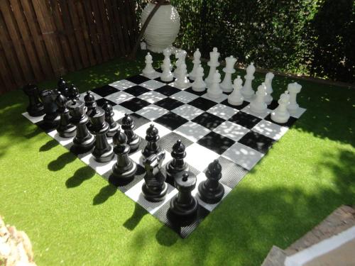 a chess board on the grass in a yard at New Aegli Resort Hotel in Poros