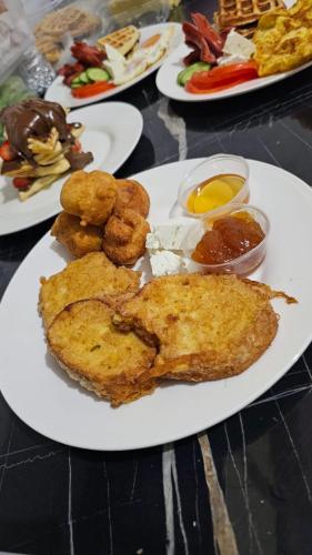 a plate of food on a table with plates of food at Square inn 11 in Tirana