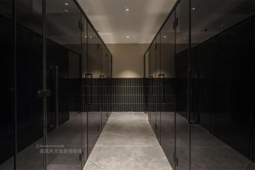 a hallway with glass doors in a building at Denpa Inn-Lao Ximen Metro Station Branch in Shanghai