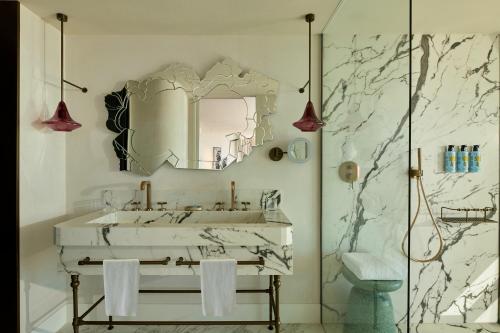 a bathroom with a white sink and a mirror at SLS Barcelona in Barcelona
