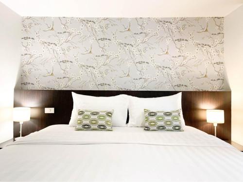 Ένα ή περισσότερα κρεβάτια σε δωμάτιο στο 24 Inn