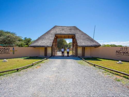 two people standing in the doorway of a building at Kayova River Lodge in Ndiyona
