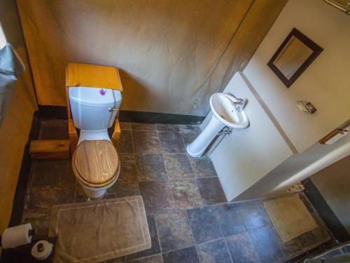 a bathroom with a toilet and a sink at Kayova River Lodge in Ndiyona