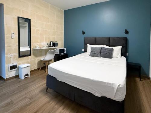 a bedroom with a large bed and a sink at Mini Studios in Central Victoria in Victoria