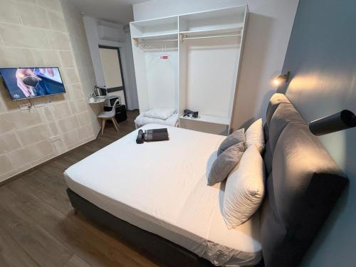 a bedroom with a large bed and a couch at Mini Studios in Central Victoria in Victoria