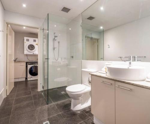 a bathroom with a toilet and a sink and a shower at Mandurah Marina Serenity in Mandurah