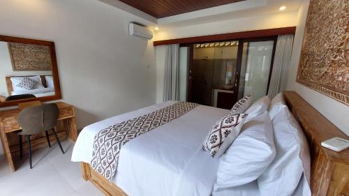 a bedroom with a bed and a desk and a window at Chic 2BR Cozy & Private Pool at Bareng Villa in Ubud