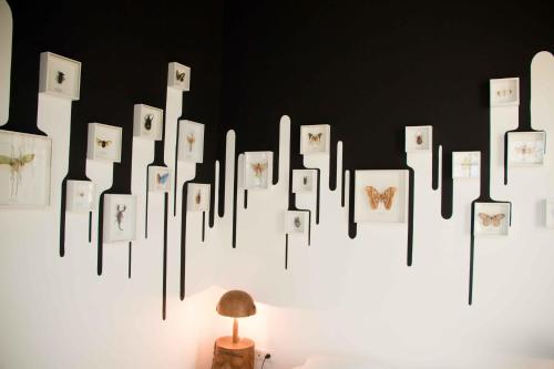 a white wall with pictures of animals on it at Surprenantes - Château du Pé in Saint-Jean-de-Boiseau