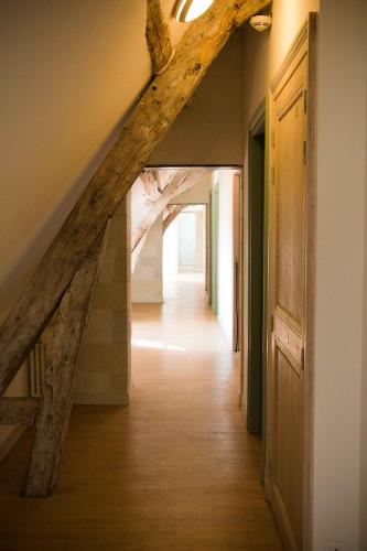 a hallway with a wooden stairway with a wooden floor at Surprenantes - Château du Pé in Saint-Jean-de-Boiseau