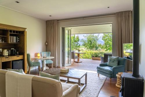 a living room with a couch and a table at Angala in Simondium