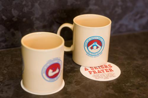 two white coffee mugs sitting on top of a counter at Station House Inn South Lake Tahoe in South Lake Tahoe