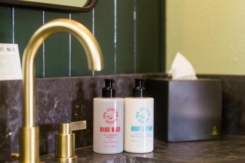 two bottles ofodorizers sitting on a bathroom sink at Station House Inn South Lake Tahoe in South Lake Tahoe