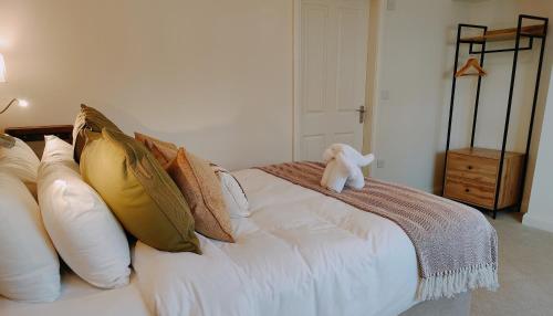 a bed with a teddy bear sitting on top of it at The Royal Oak in Gillamoor