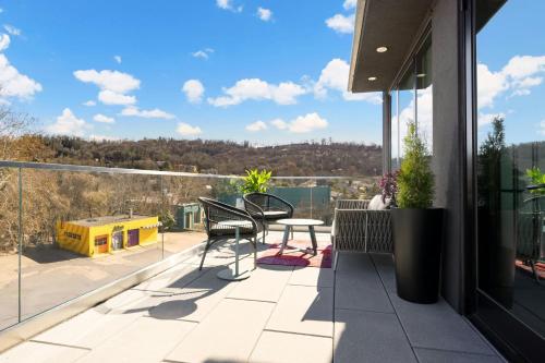 a patio with a table and chairs on a balcony at Moxy Asheville in Asheville