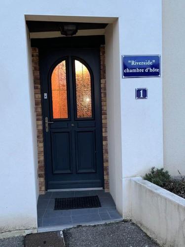 a blue door of a building with a sign on it at Riverside in Longeville-en-Barrois
