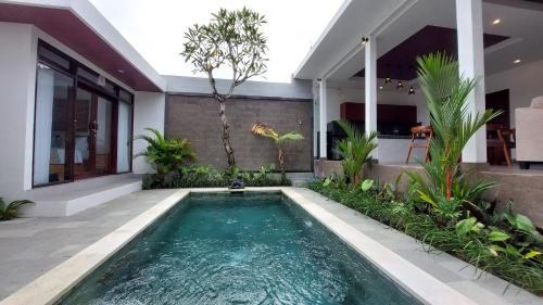 a swimming pool in the backyard of a house at Chic 2BR Cozy & Private Pool at Bareng Villa in Ubud