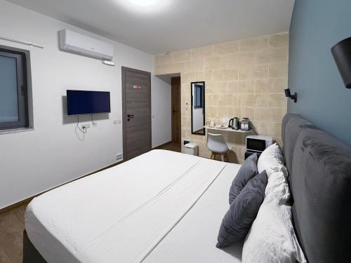 a hotel room with a bed and a bathroom at Mini Studios in Central Victoria in Victoria
