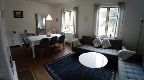 a living room with a couch and a table at Villa Lilly, near Vimmerby in Vimmerby