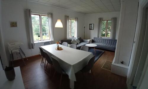 a living room with a table and a couch at Villa Lilly, near Vimmerby in Vimmerby