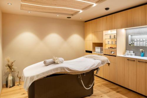 a hospital room with a bed and a kitchen at Familienhotel Huber in Valles