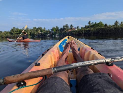 a person is paddling a kayak on the water at Madampa Ganga Villa. in Ambalangoda