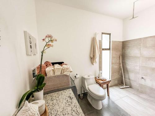 a white bathroom with a toilet and a shower at Adults Only - Dreamers Refuge in Parrita