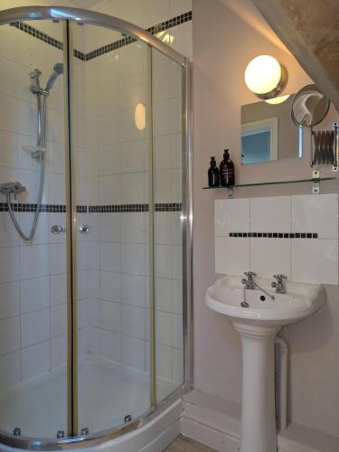 a bathroom with a shower and a sink at South Cotswolds cottage in Great Somerford