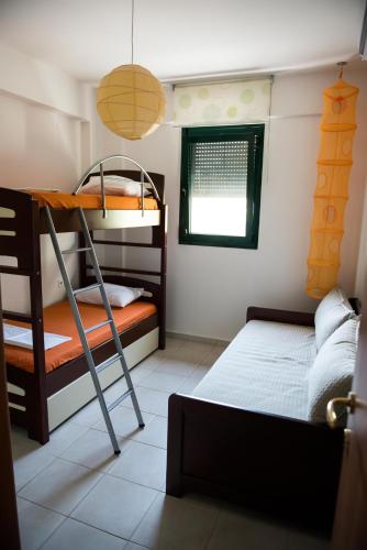 a bedroom with a bunk bed and a bunk bed gmaxwell gmaxwell gmaxwell gmaxwell at Maisonette with sea and mountain view !!! in Kriopigi