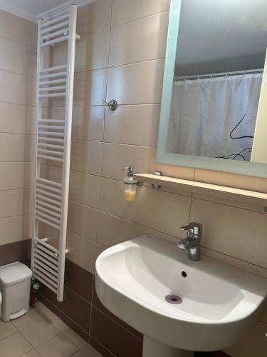 a bathroom with a sink and a mirror and a toilet at Thermos House Nydri in Nydri