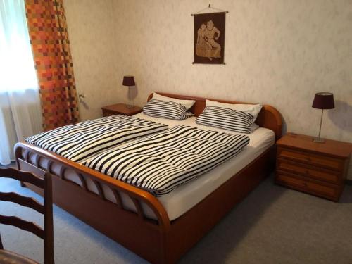a bedroom with a bed with two pillows on it at Café Pension Sonnenkanzel in Staatsbad Brückenau