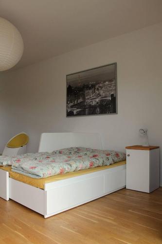a bed in a room with a white bed frame at Ferienwohnungen Meyerhoff Temmen in Temmen-Ringenwalde