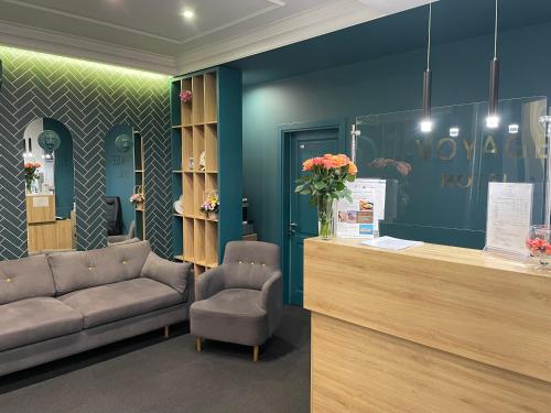 a waiting room with a couch and a reception desk at Voyage in Odesa