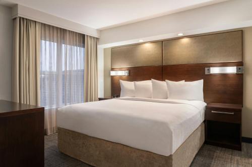 a hotel room with a large bed and a window at Residence Inn by Marriott Akron Fairlawn in Fairlawn