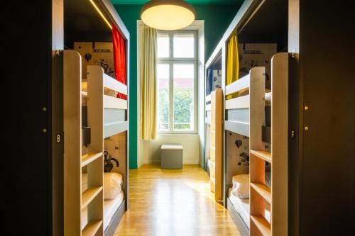 a hallway with bunk beds in a room with a window at The People - Strasbourg in Strasbourg