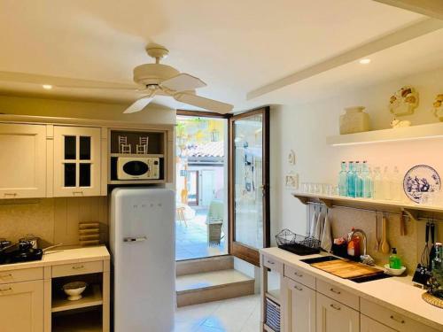 a kitchen with a white refrigerator and a sliding glass door at Da Gianni e Villa Annamaria in Arco