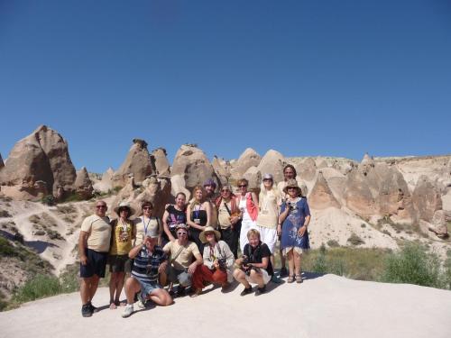 a group of people posing for a picture in front of rocks at Karlık Evi Hotel - Special Category in Uchisar