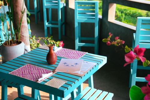 a blue table with a book and a vase on it at Ceylon's House in Hikkaduwa
