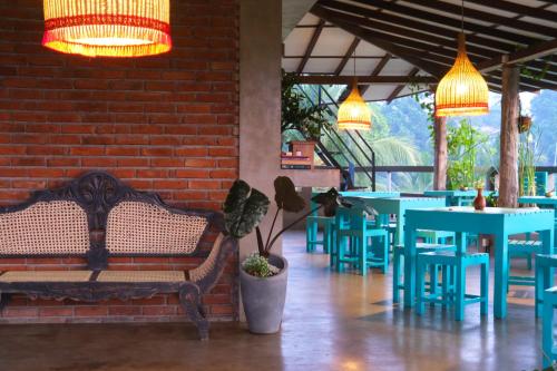 a restaurant with blue tables and benches and lights at Ceylon's House in Hikkaduwa