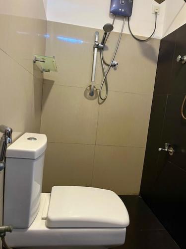 a bathroom with a white toilet and a shower at Kamatha Hotel & Restaurant in Ambalantota