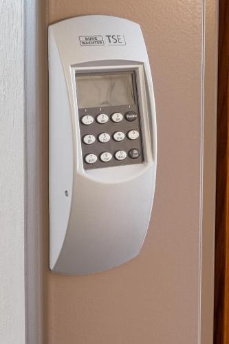 a white cabinet with a calculator on a wall at Bamberg Inn in Hallstadt