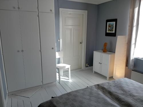 a bedroom with a bed and a white cabinet at Villa Lilly, near Vimmerby in Vimmerby