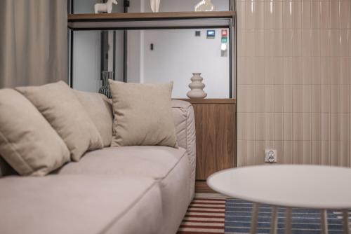 a living room with a white couch and a table at Noli Gdansk Wrzeszcz in Gdańsk