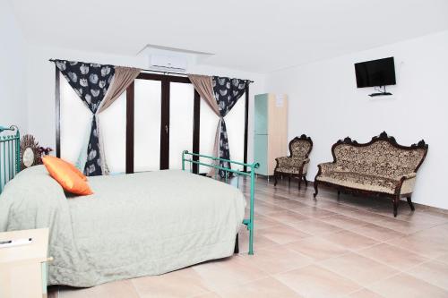 una camera con un letto, due sedie e una TV di Valle Chiara a Ostellato